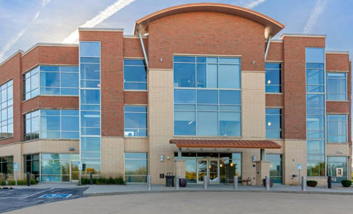 front of modern 3 story office building